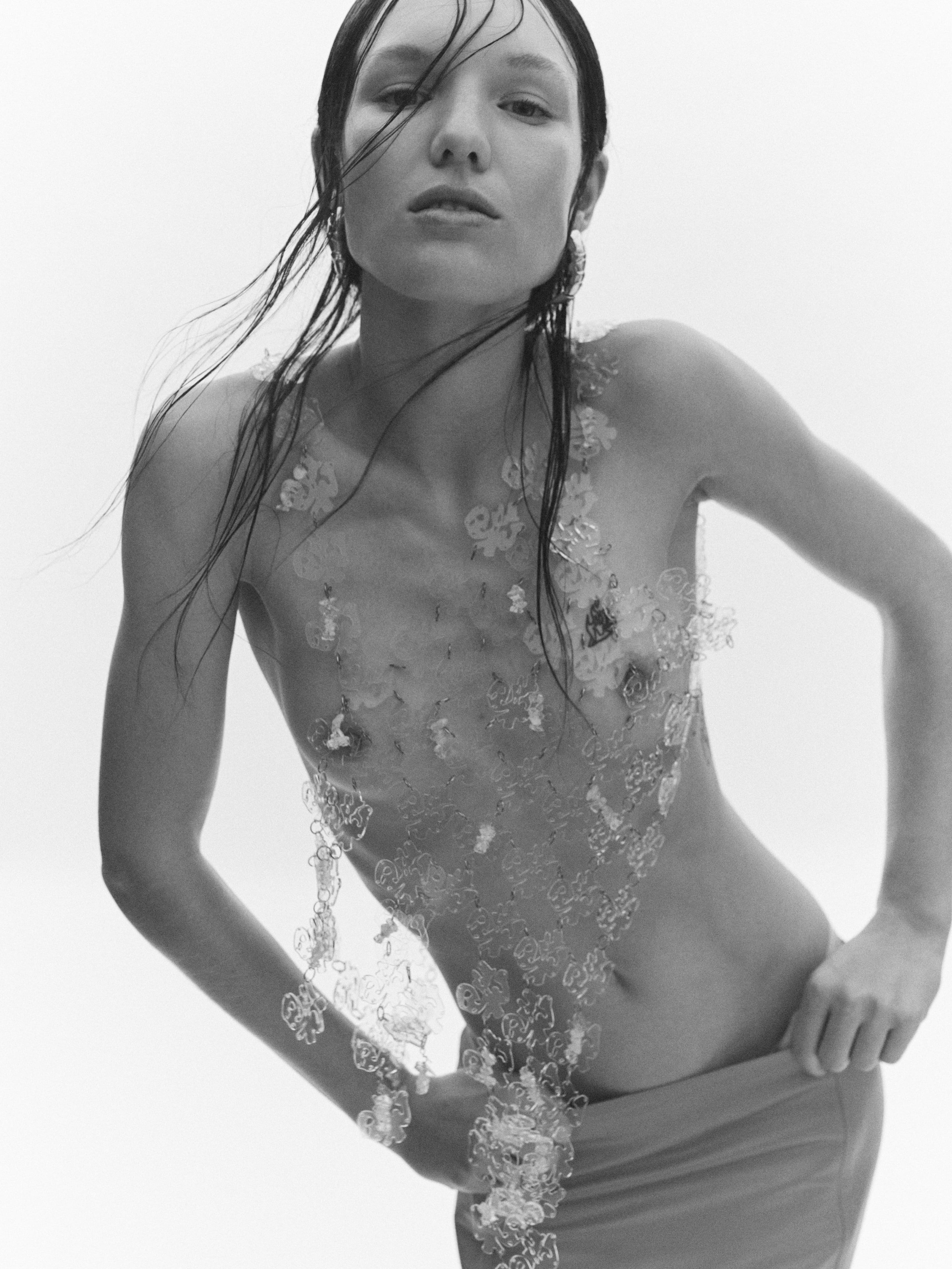 Top by Xi Wu Studio. Skirt by Prada. Earrings by Bottega Veneta.