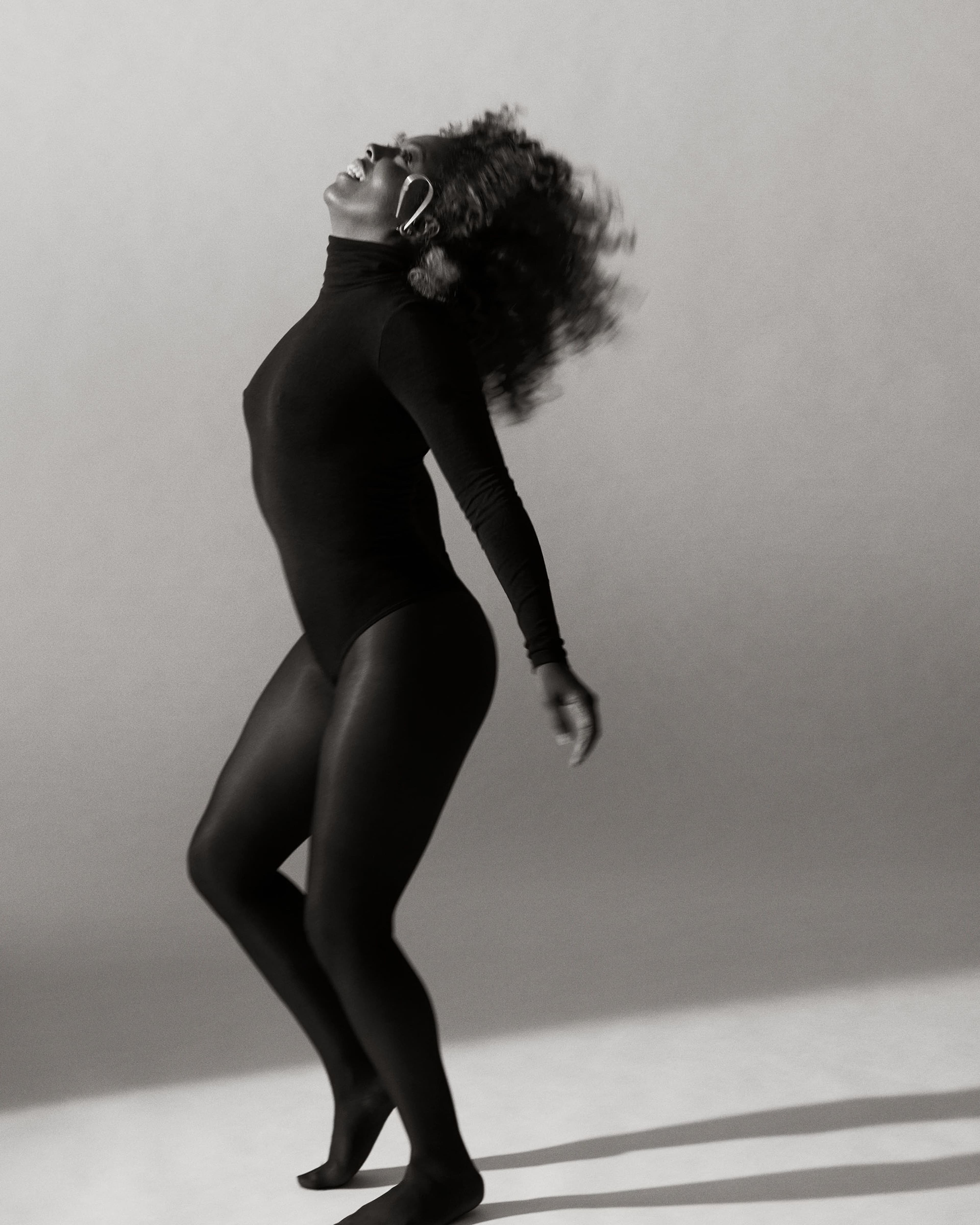 Bodysuit by Wolford. Tights by Calzedonia. Earrings by Jennifer Fisher.