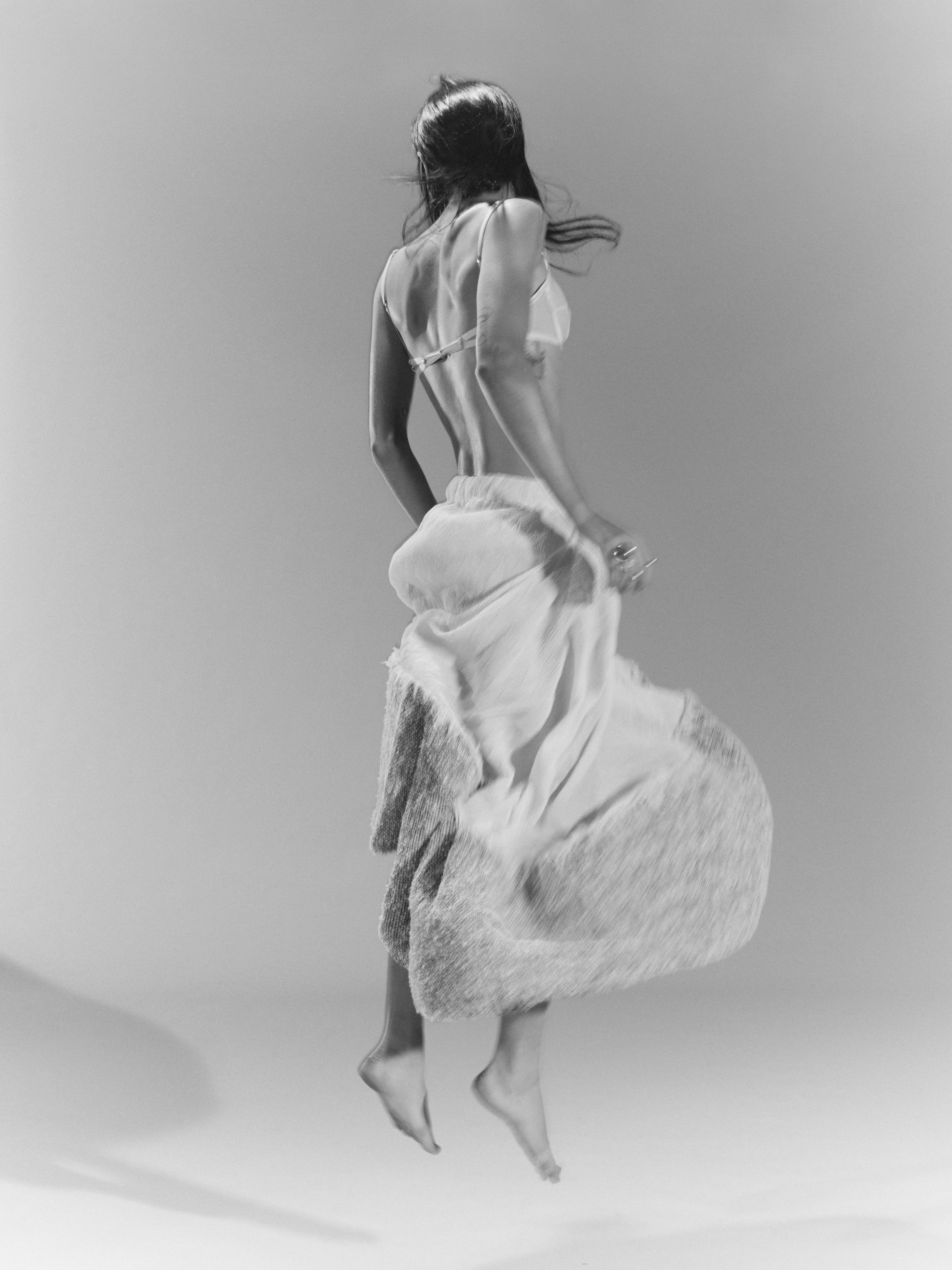 Bra by Jasmin Sparrow. Bra, worn underneath, by Sportmax. Skirt by Jordan Dalah. Rings by Bottega Veneta, Chanel, Dinosaur Designs, and Louise Olsen.