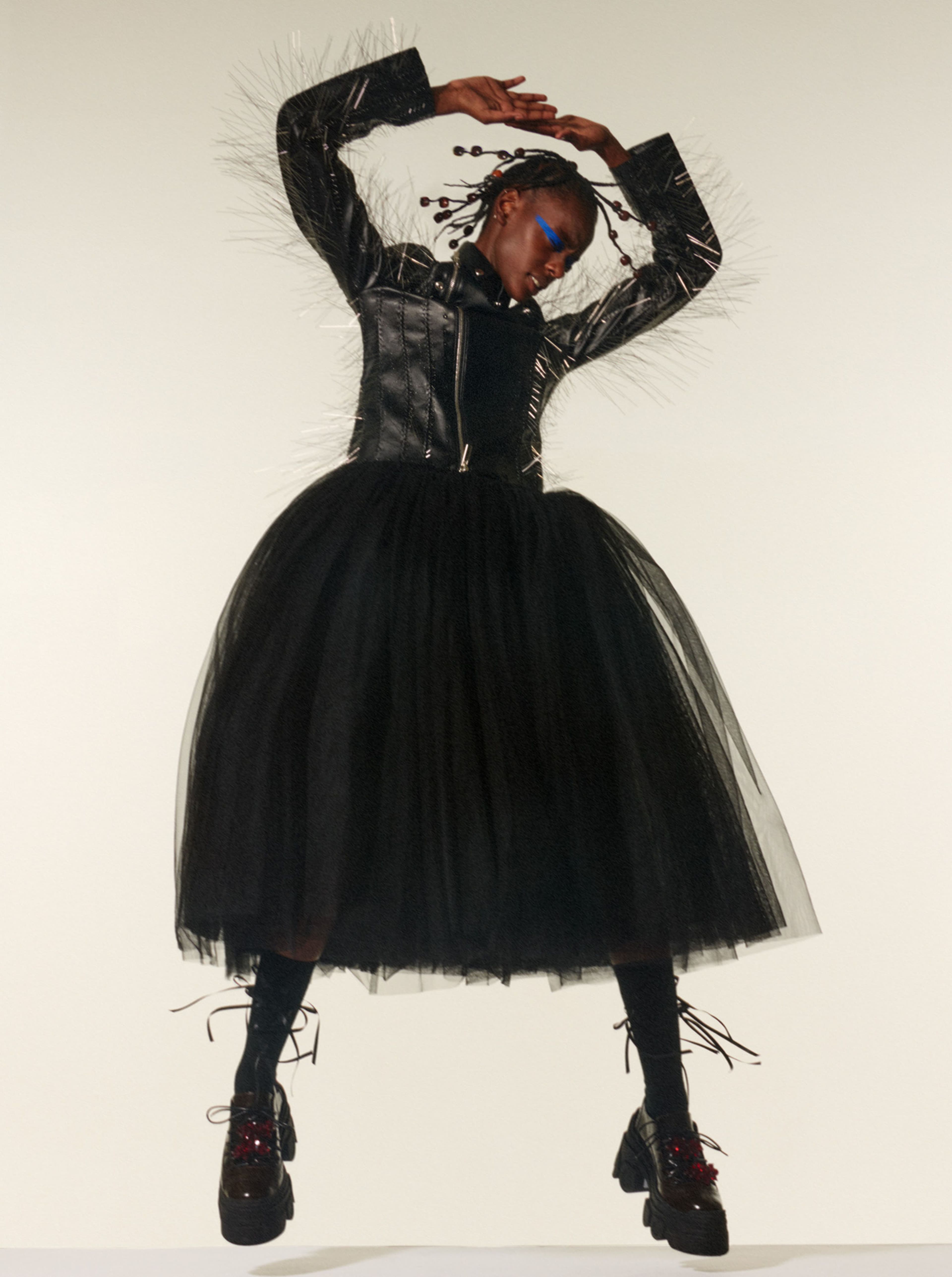 Coat and skirt by Noir Kei Ninomiya. Socks and shoes by Simone Rocha.