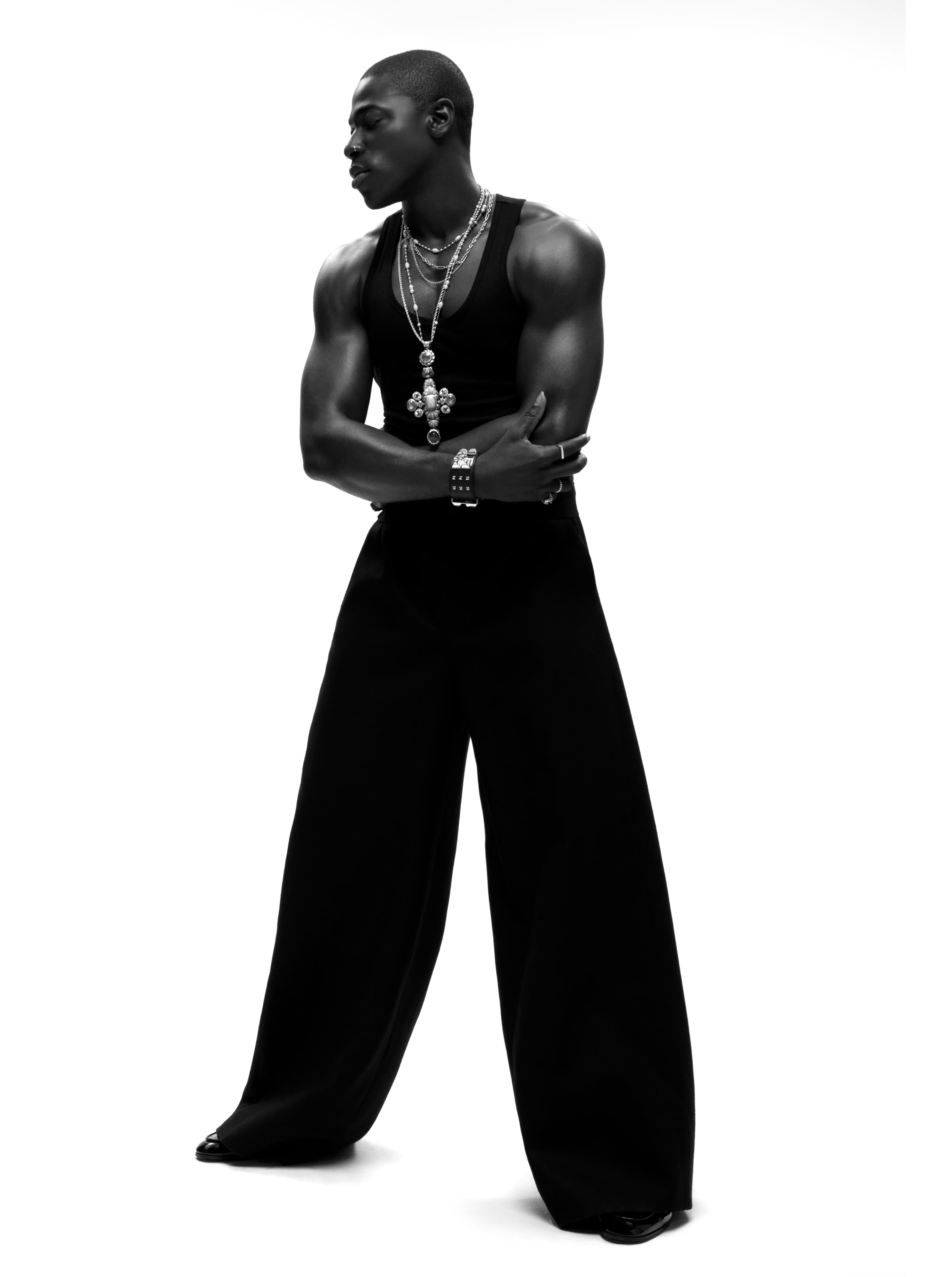 TOP by ,Second Layer,. PANTS by ,Sacai., CUMMERBUND by ,Dior., SHOES by ,Gianvito Rossi. ,NECKLACE by ,Sabyasachi. ,BRACELETS by ,Hermès., RINGS by ,HOWL,, ,Mateo,, and ,Miansai,, and Sumney’s own.