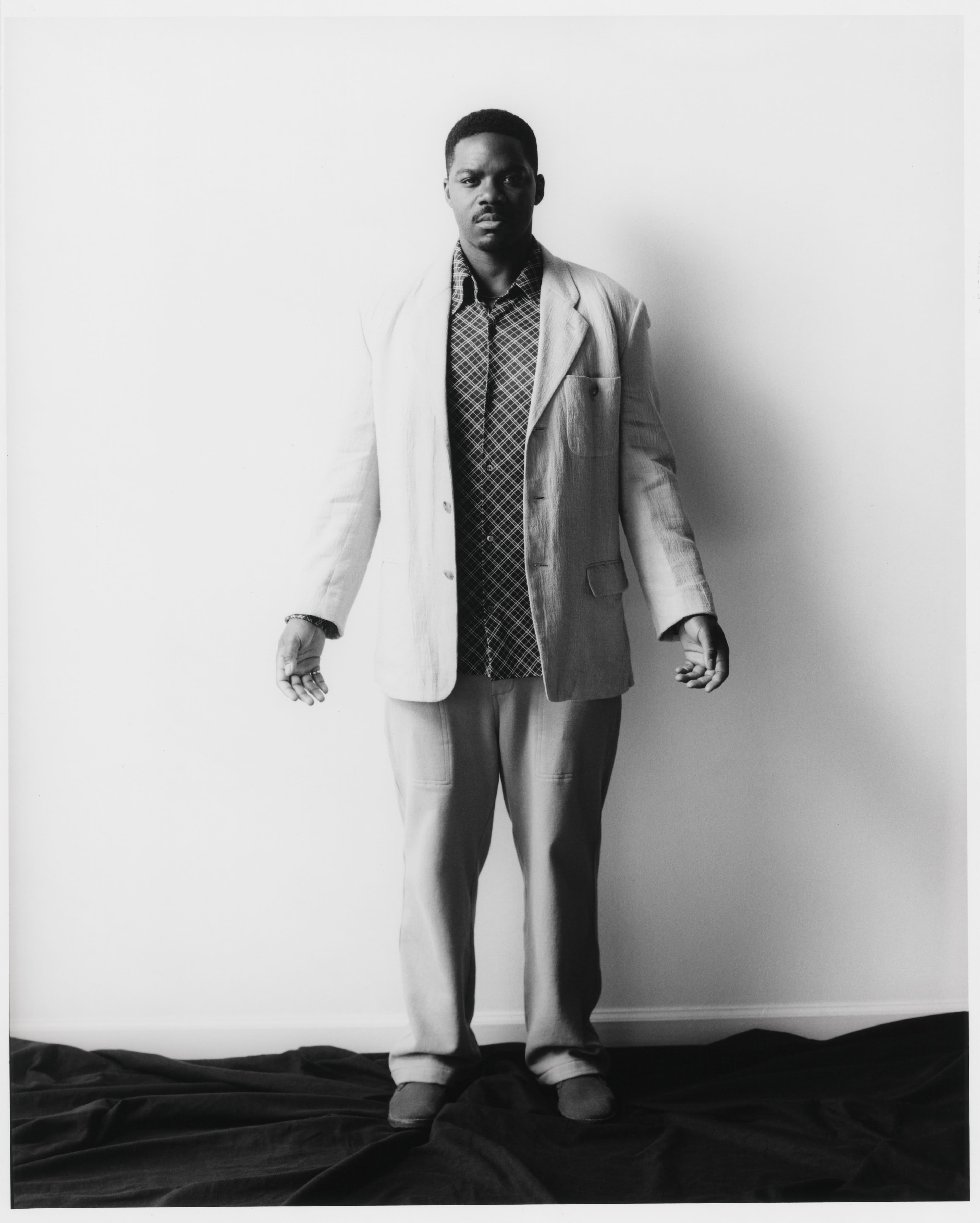 Vintage jacket by Issey Miyake from The RealReal. Vintage shirt by Maison Margiela from Arara Archive. Pants by Bode. Shoes by Clarks.