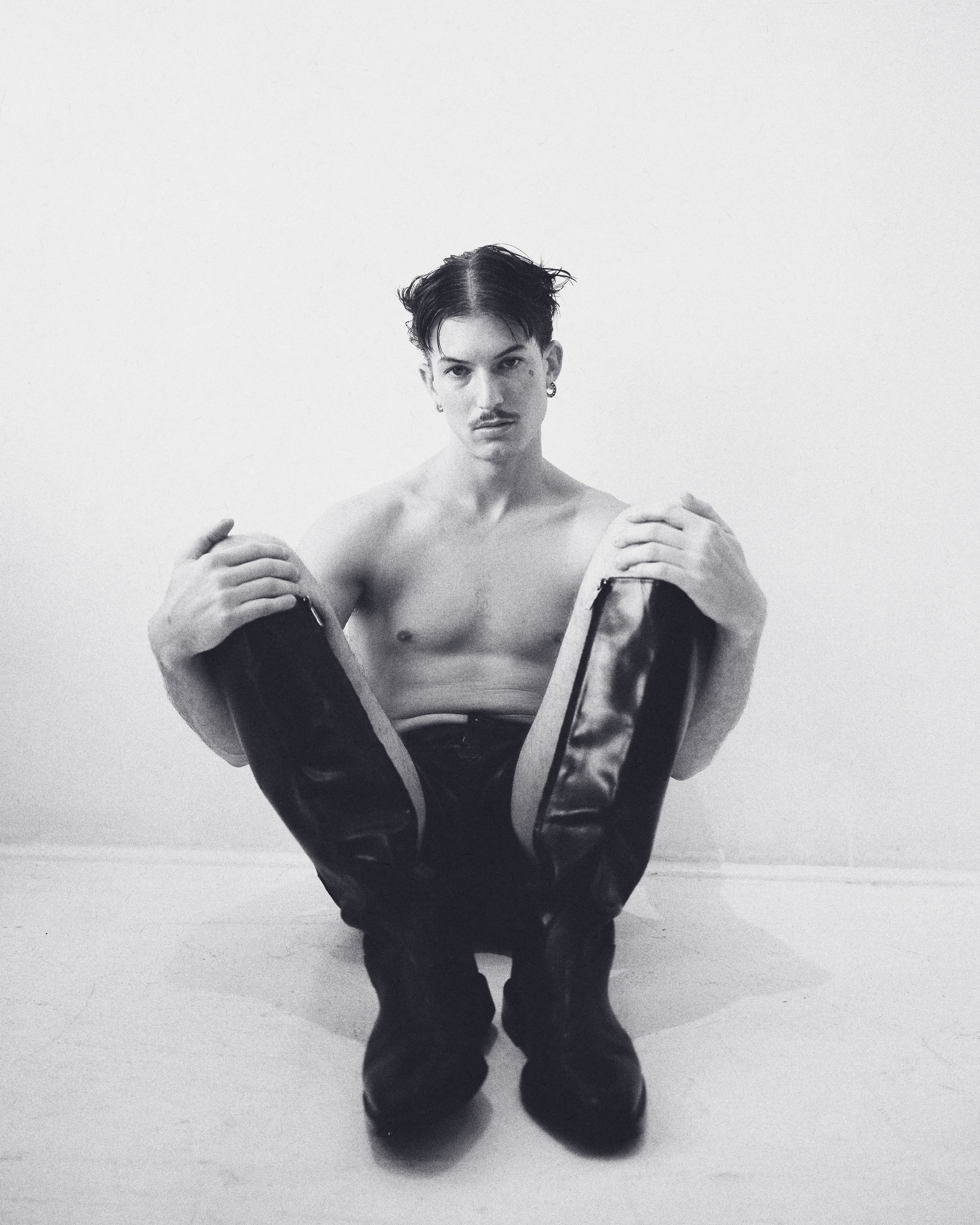 Shorts and boots by Ferragamo. Earrings by Spinelli Kilcollin.