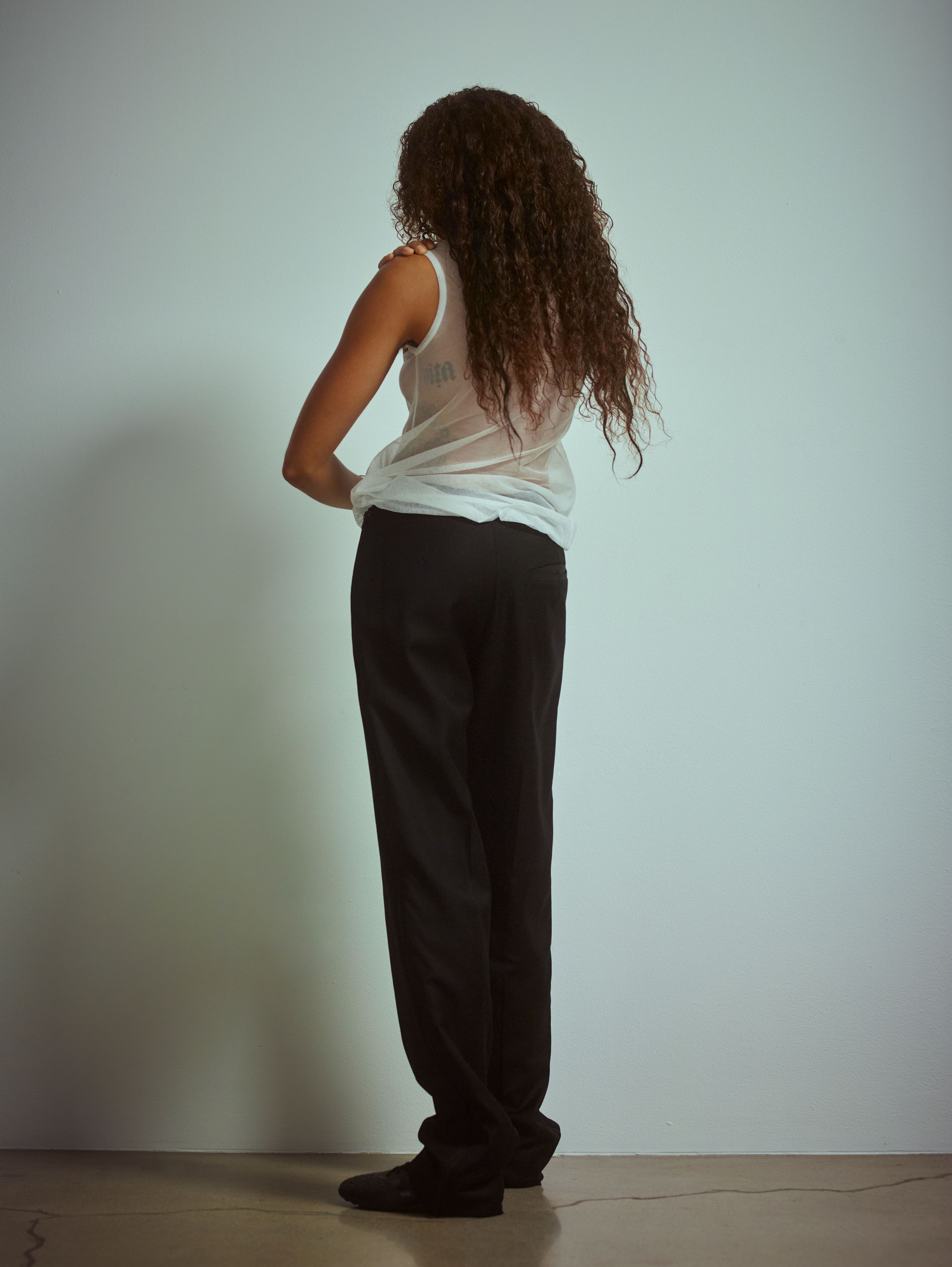 Vintage top by Helmut Lang. Vintage pants by Raf Simons. Vintage sneakers by Adidas.