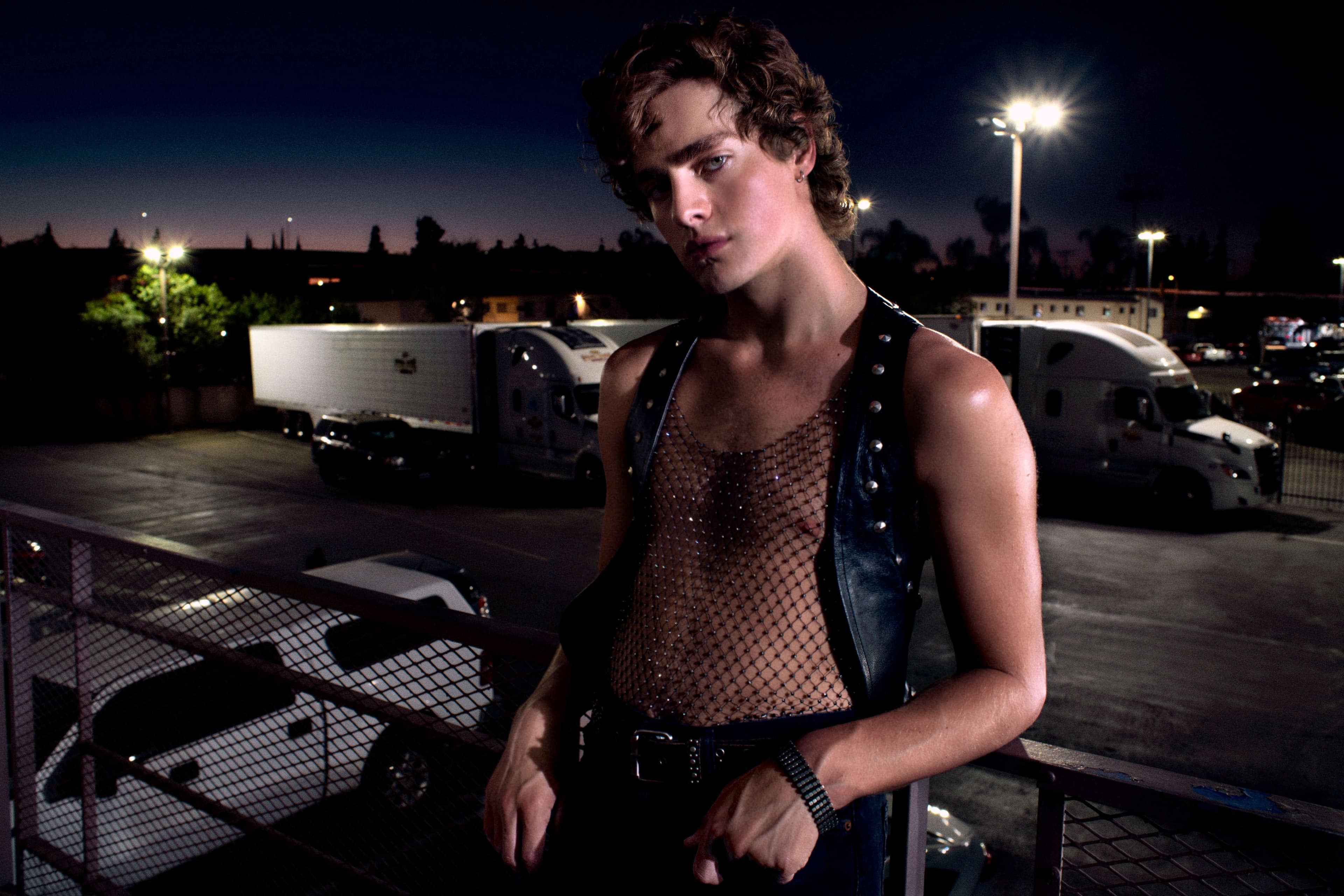 Vintage vest and bracelet. Top by Saint Laurent. Shorts by AGOLDE. Boots by Alexander McQueen.