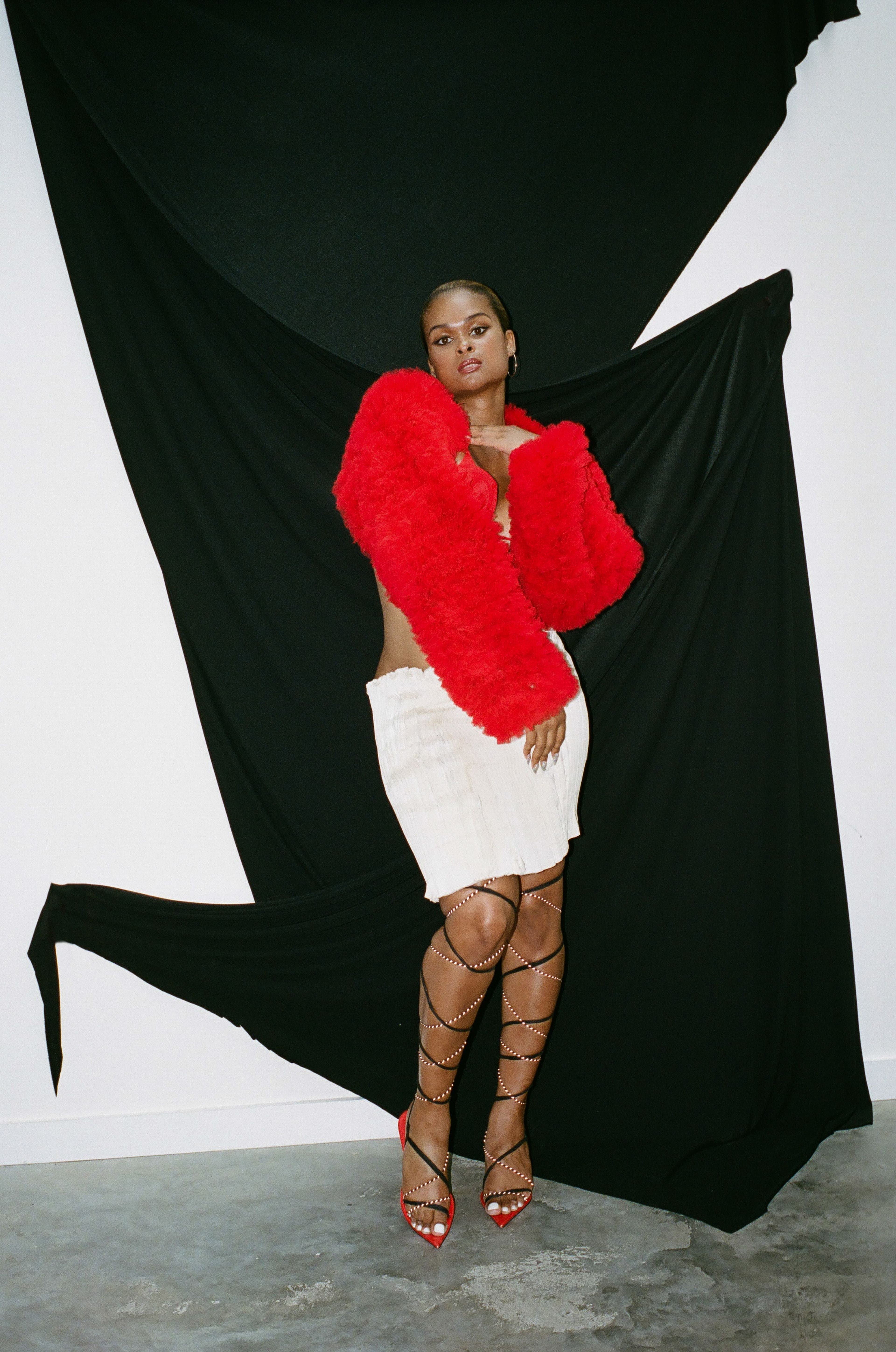 Vintage jacket by LaQuan Smith from Albright Fashion Library. Vintage bra by Magda Butrym from Albright Fashion Library. Vintage skirt by Helmut Lang from Albright Fashion Library. Earrings, stylist’s own.